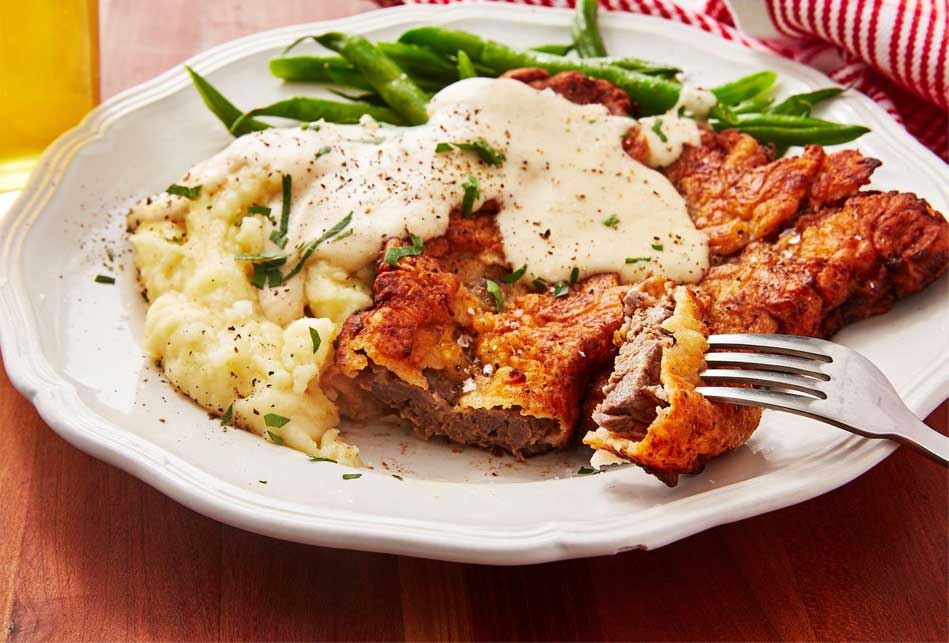 Chicken fried steak with mashed potatoes and gravy.